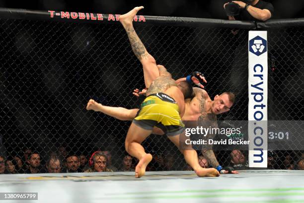 Rafael Dos Anjos of Brazil and Rafael Fiziev of Kazakhstan fight in their lightweight bout during UFC 272 at T-Mobile Arena on March 05, 2022 in Las...