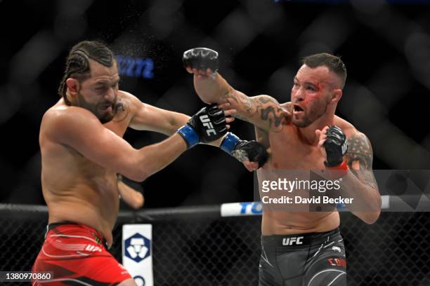 Colby Covington punches Jorge Masvidal in their welterweight fight during UFC 272 at T-Mobile Arena on March 05, 2022 in Las Vegas, Nevada.