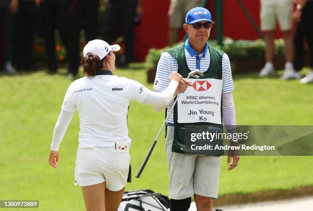 Jin Young Ko of South Korea celebrates with her caddie David Brooker after putting in for a birdie to win during the Final Round of the HSBC Women's...