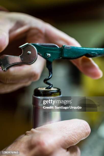 opening a bottle of red wine - corkscrew foto e immagini stock