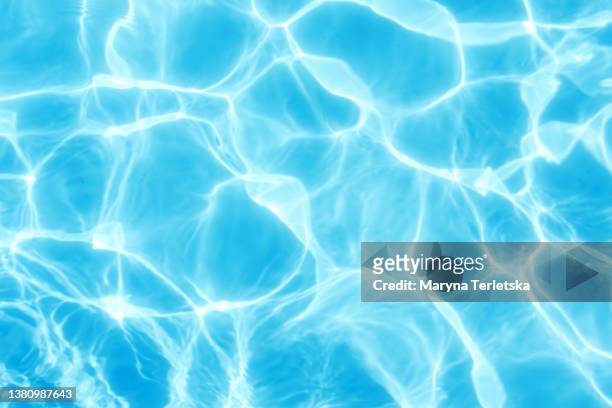 beautiful sun reflections of water in the pool. summer. flight holidays. blue water. background. rest in the pool. pure water. waves. blue background. - piscine photos et images de collection