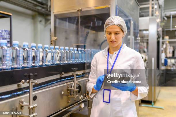female engineer working on maintenance in bottling plant - bottling stock pictures, royalty-free photos & images