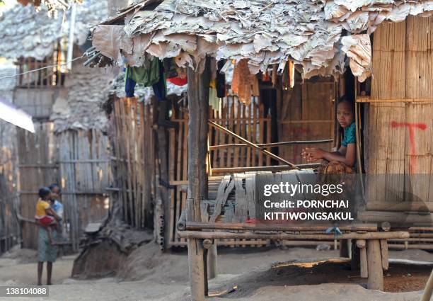 Karen refugee sits in her shelter at Mae La refugee camp in Mae Sot near the Thai-Myanmar border on January 29, 2012. More than 140,000 refugees have...