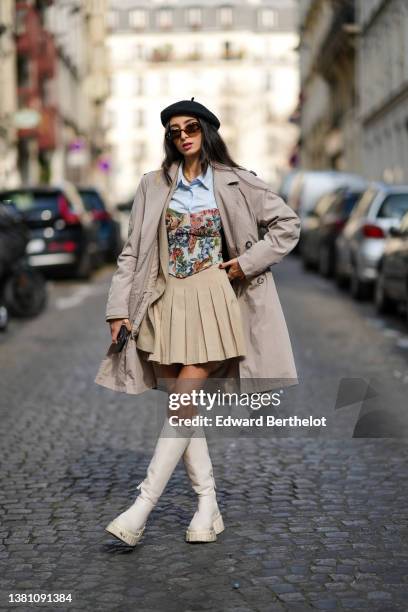 Guest wears a black felt / wool beret, brown sunglasses, a pale blue shirt, a beige long coat, a beige with green / red / blue flower print pattern...