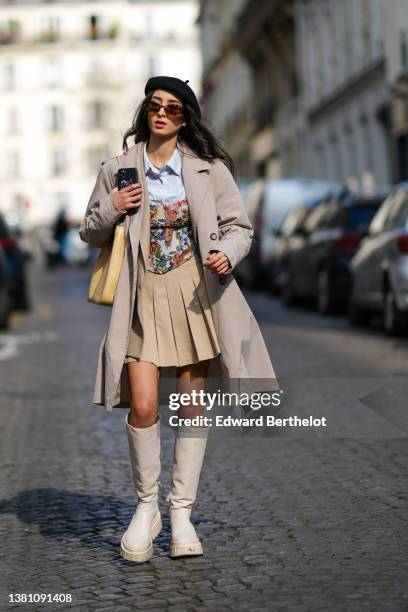 Guest wears a black felt / wool beret, brown sunglasses, a pale blue shirt, a beige long coat, a beige with green / red / blue flower print pattern...