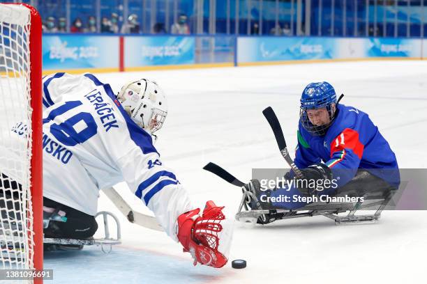 Nils Larch of Team Italy scores against Eduard Lepacek of Team Slovakia in a shootout during the Group B Preliminary Round Para Ice Hockey game on...