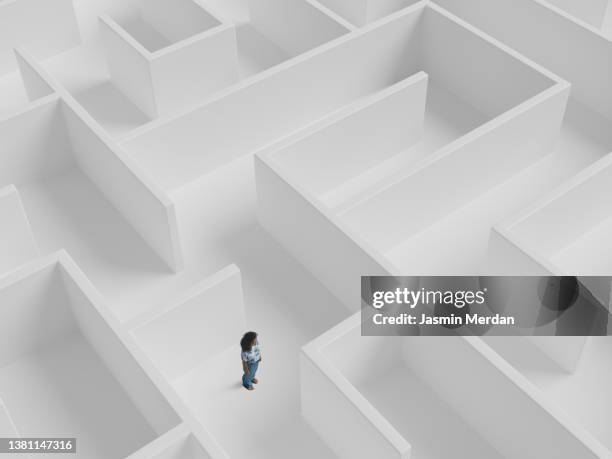 woman standing inside the maze - labyrinth stock-fotos und bilder