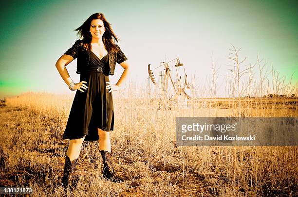 woman standing in oil jack field - lubbock texas stock pictures, royalty-free photos & images
