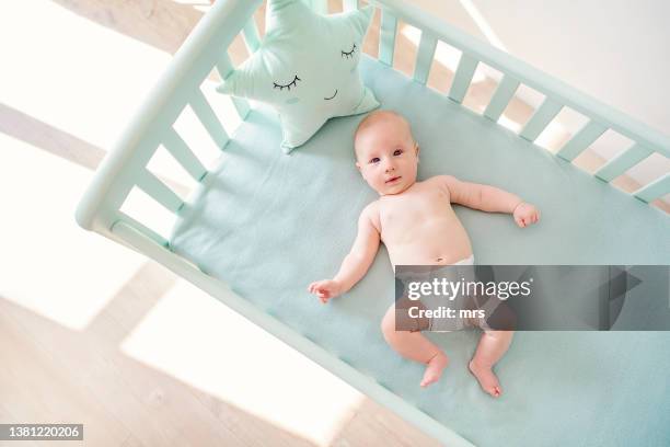 cute baby lying in the crib - 4 months stock pictures, royalty-free photos & images