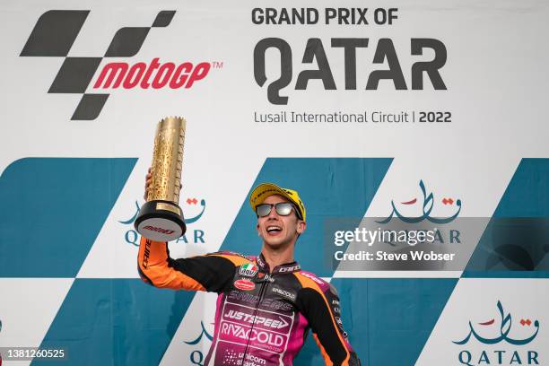 Moto3 race winner Andrea Migno of Italy and Rivacold Snipers Team celebrates on the podium with his trophy during the MotoGP Grand Prix of Qatar at...