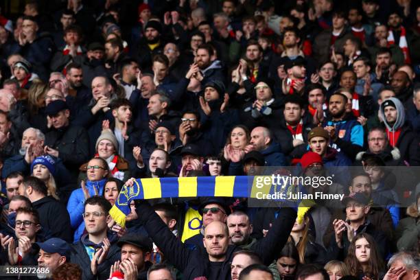 An Arsenal scarf in the colours of the Ukraine flag is held up in the crowd to indicate peace and sympathy with Ukraine ahead of the Premier League...