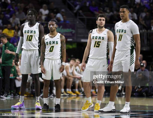 Josh Kunen, Khalil Shabazz, Gabe Stefanini and Patrick Tape of the San Francisco Dons stand on the court as they take on the Brigham Young Cougars...