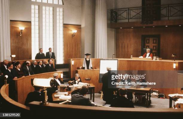 Actress Laura San Giacomo stands up in court in a scene from the thriller 'Under Suspicion', 1991.