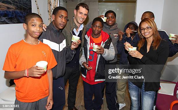 Michael Sloan of The Soft Serve Fruit poses with youth from Urban Promise during Celebrities For Smiles hosted by Kris Humphries at Smile Design...