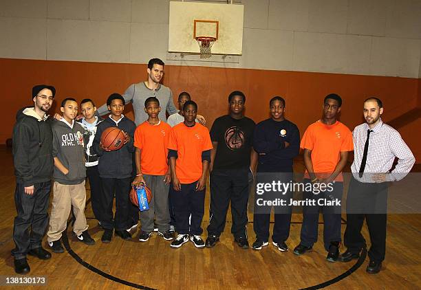 Kris Humphries poses with youth at Urban Promise after surprising them with a trip to NYC for free dental work by Smile Design Manhattan on February...