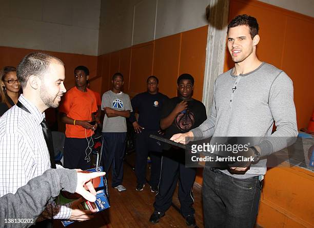 Kris Humphries receives a gift from the students at Urban Promise after surprising 12 youth with a trip to NYC for free dental work by Smile Design...