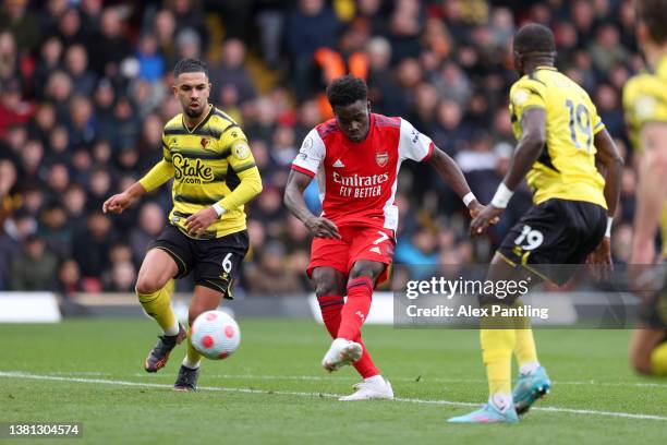 Bukayo Saka of Arsenal scores their sides second goal during the Premier League match between Watford and Arsenal at Vicarage Road on March 06, 2022...