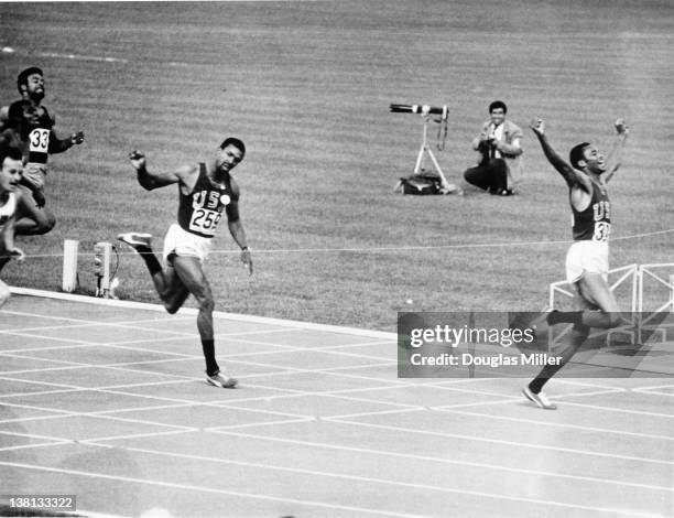 Tommie Smith of the USA wins the men's 200 metres final at the Olympic Games in Mexico City, 16th October 1968. Bronze medallist John Carlos, also of...