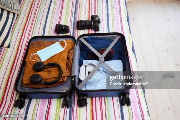 packing suitcase for travel during covid-19 - andersdahl65 stock pictures, royalty-free photos & images