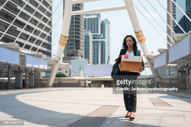 desperate businesswoman on line worried after unemployed at staircase with her hands in the head. - lay off stock pictures, royalty-free photos & images