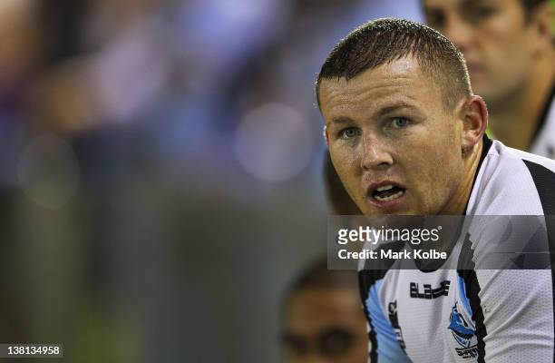 Todd Carney of the Sharks watches on from the bench during the NRL trial match between the Cronulla Sharks and the Manly Warringah Sea Eagles at...