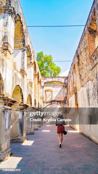 beautiful girl walking in ruins of historical building.  san francisco convent, antigua - guatemala - antigua guatemala stock-fotos und bilder