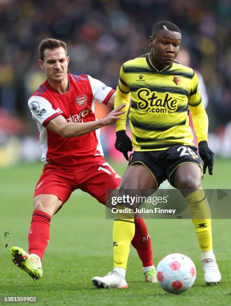 Samuel Kalu of Watford FC is challenged by Cedric Soares of Arsenal during the Premier League match between Watford and Arsenal at Vicarage Road on...