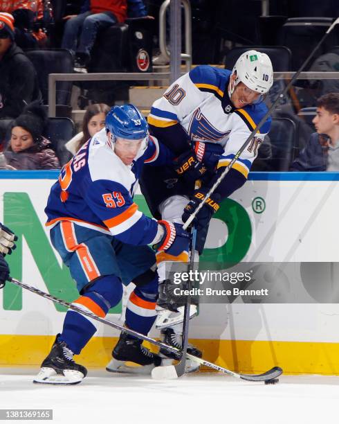 Brayden Schenn of the St. Louis Blues is checked by Casey Cizikas of the New York Islanders at the UBS Arena on March 05, 2022 in Elmont, New York.
