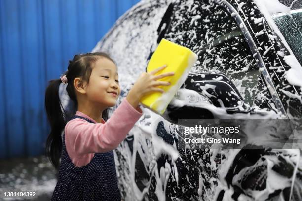 girls washing car for their father. - girls taking a showering stockfoto's en -beelden