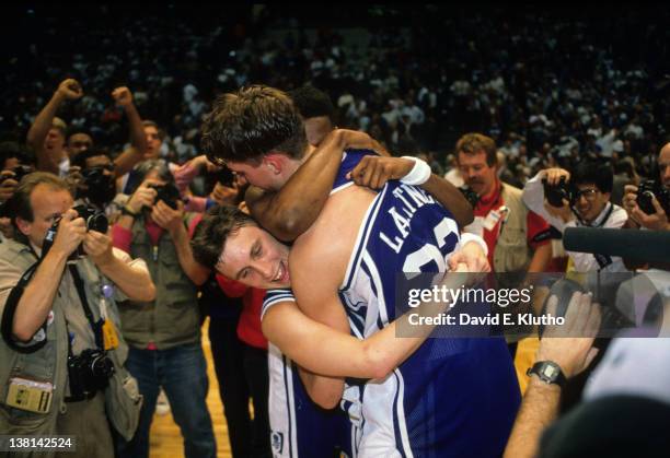 Playoffs: Duke Christian Laettner and Bobby Hurley victorious, hugging on court after game-winning shot vs UConn at the Brendan Byrne Arena. East...