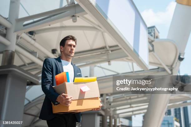 fired frustrated man in suit sitting at stairs outside office. - stellenabbau stock-fotos und bilder