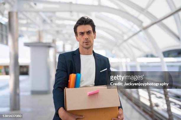 businessman leaving the office after being fired from his job. - quitting a job stock-fotos und bilder
