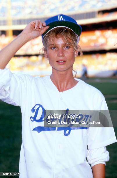 Actress Nicollette Sheridan participates in the Hollywood Stars celebrity softball game wearing a Dodger uniform at Dodger Stadium in1989 in Los...