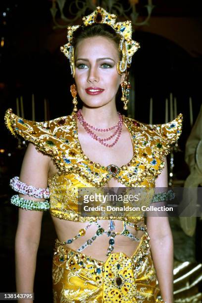 Actress Hunter Tylo attends an event wearing an intricately bejewelled dress and head dress in March 1992 in Los Angeles, California.