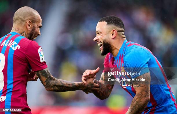 Memphis Depay of FC Barcelona celebrates with his teammates Dani Alves of FC Barcelona after scoring his team's second goal during the LaLiga...