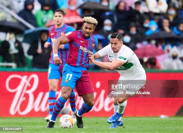 Adama Traore of FC Barcelona duels for the ball with Ivan Marcone of Elche CF during the LaLiga Santander match between Elche CF and FC Barcelona at...