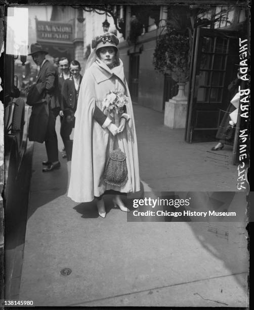 Silent film actress Theda Bara standing outside the Blackstone Theater, Chicago, Illinois, 1917.