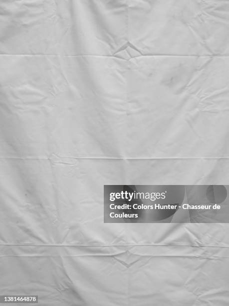 clean and empty white plastic sheet in brussels - tarpaulin stockfoto's en -beelden