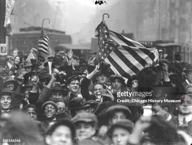 Armistice Day peace celebration, crowd of mostly boys, on a street, looking up toward the camera, Chicago, Illinois, November 11th, 1918.