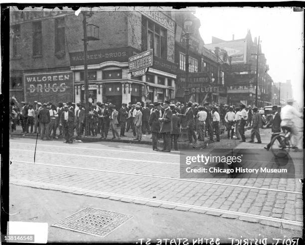 Chicago race riot, African American men standing in front of Walgreen Drugs, 35th and State, Chicago, Illinois, July 30, 1919.