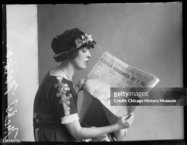 Mabel Normand, silent film actress, sitting reading copy of Chicago Daily News, Chicago, Illinois, 1921.
