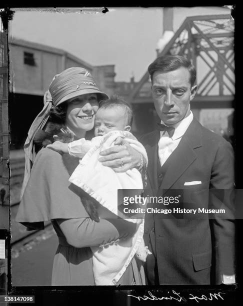 Married actors Buster Keaton and Natalie Talmadge standing on a train platform with their baby, Joseph , Chicago, Illinois, 1922.