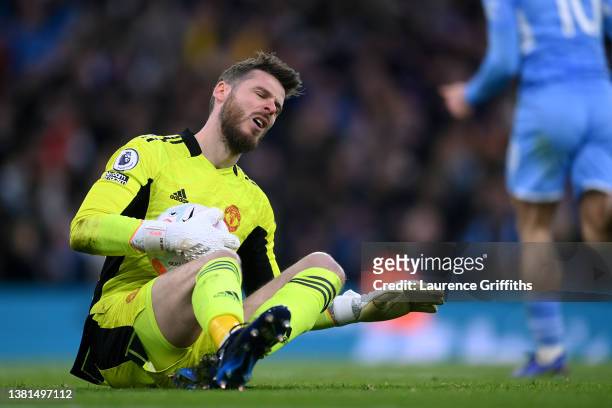 David De Gea of Manchester United reacts after Riyad Mahrez of Manchester City scores their sides third goal during the Premier League match between...