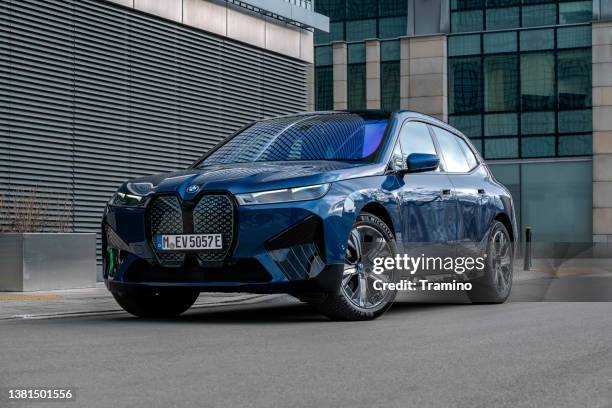 electric suv bmw ix on a street - bmw stock pictures, royalty-free photos & images