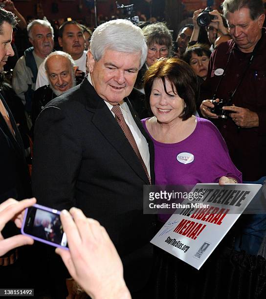 Republican presidential candidate and former Speaker of the House Newt Gingrich poses for a photo with Diane George of Nevada after he spoke at a...