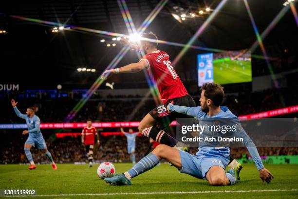 Bruno Fernandes of Manchester United competes for the ball with Bernado Silva of Manchester City during the Premier League match between Manchester...