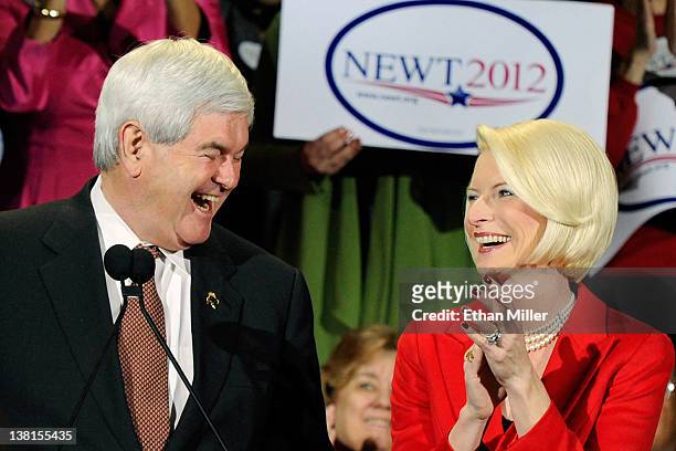 Republican presidential candidate and former Speaker of the House Newt Gingrich and his wife Callista Gingrich laugh during a campaign rally at...