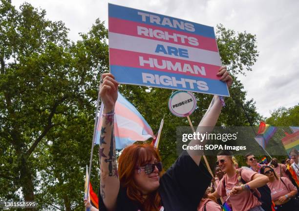 Participant holds a 'Trans rights are human rights' placard during this year's Pride in London Parade. Pride Parade, as one of the highlights of...