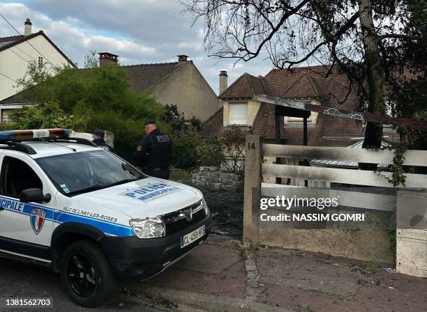 Municipal police officer stands in front of the damaged home of the Mayor of l'Hay-les-Roses Vincent Jeanbrun, in l'Hay-les-Roses, a suburb of Paris...