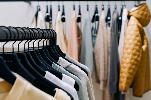 Shopping fashion sale background. colorful clothes on hangers. selective focus